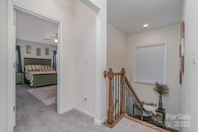 hall with light colored carpet