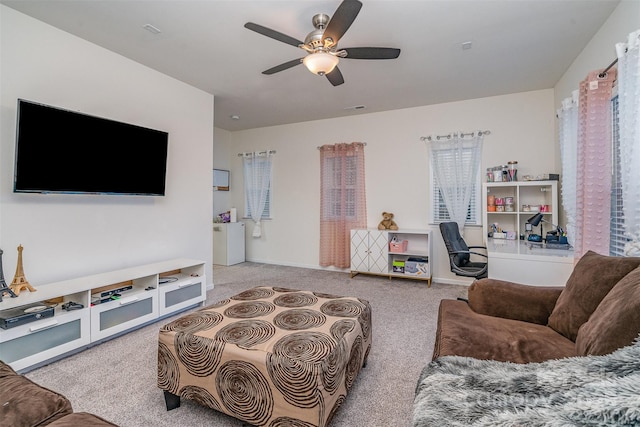carpeted living room with ceiling fan