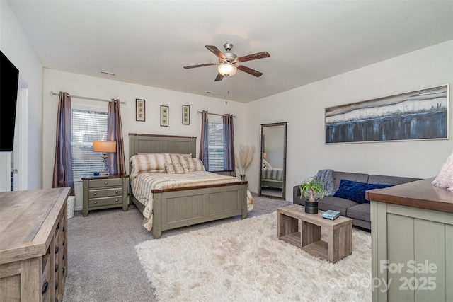 bedroom featuring light carpet and ceiling fan