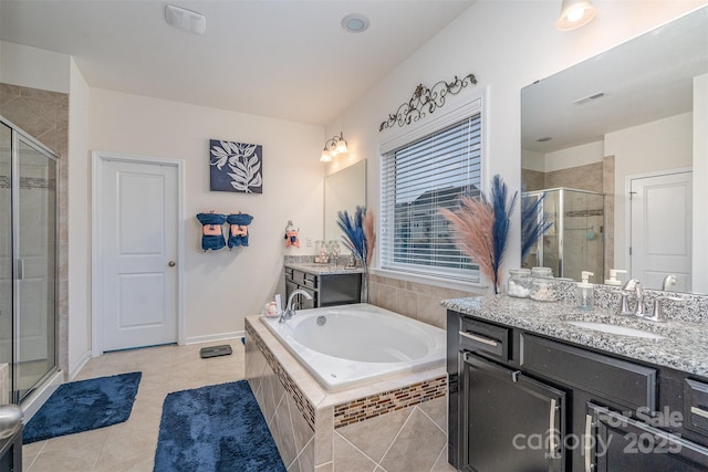 bathroom with vanity, tile patterned floors, and plus walk in shower