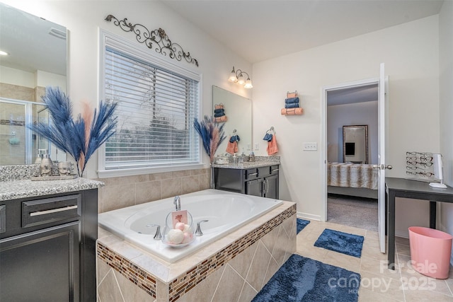 bathroom featuring vanity, shower with separate bathtub, and tile patterned flooring