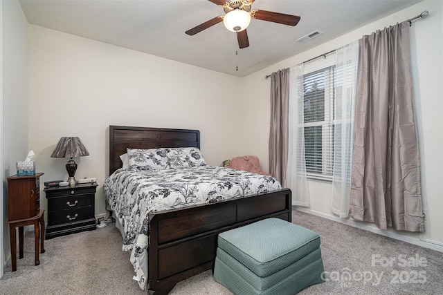 bedroom with ceiling fan and light carpet