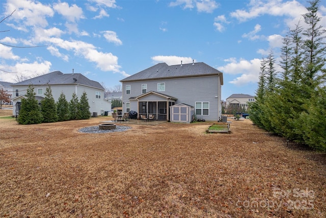 back of property featuring a sunroom and a fire pit