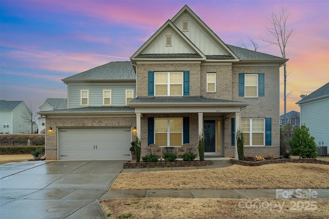 craftsman inspired home with a garage and covered porch