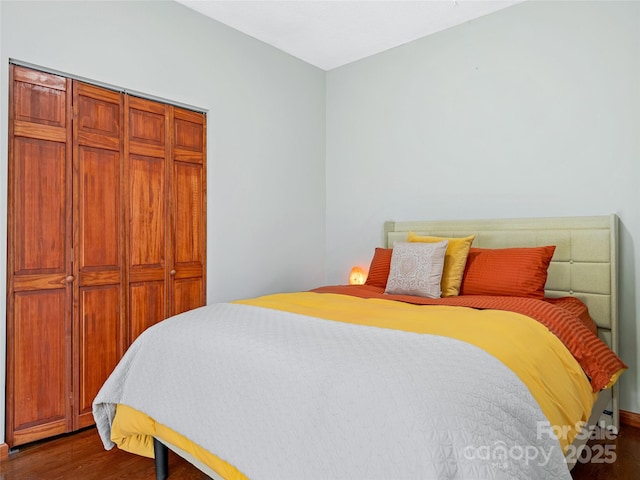 bedroom with a closet and dark wood-style flooring