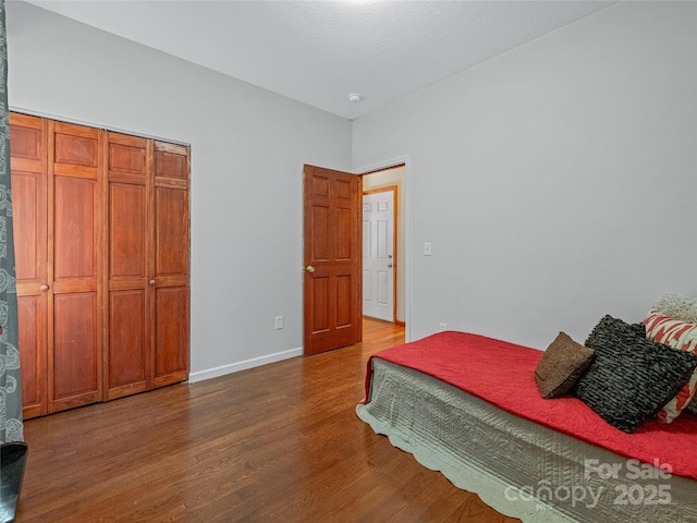 bedroom with wood finished floors and baseboards