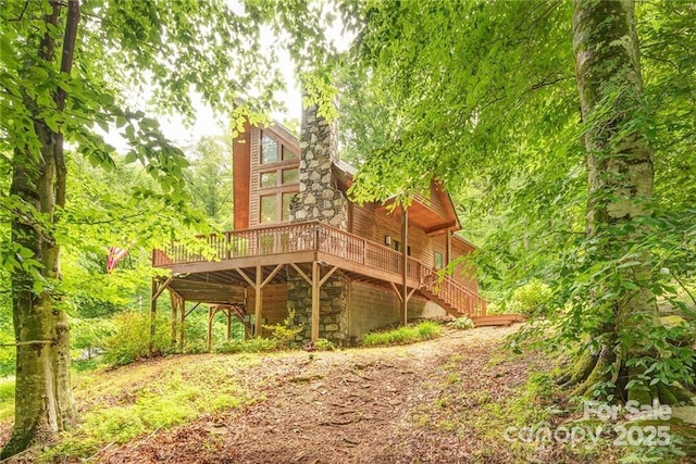 back of house with stairway and a deck