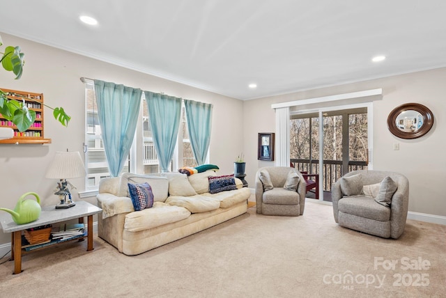 carpeted living area featuring baseboards, ornamental molding, and recessed lighting