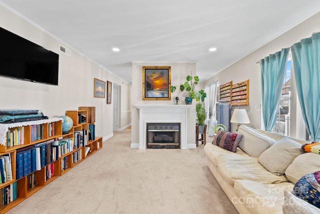 living room with light carpet, baseboards, visible vents, a fireplace with flush hearth, and crown molding