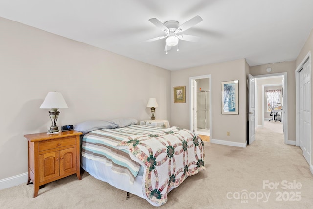 bedroom with baseboards, a ceiling fan, light colored carpet, ensuite bathroom, and a closet