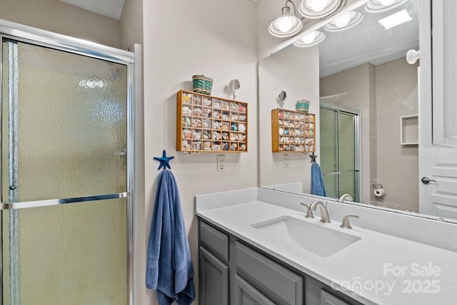 full bathroom with a stall shower and vanity