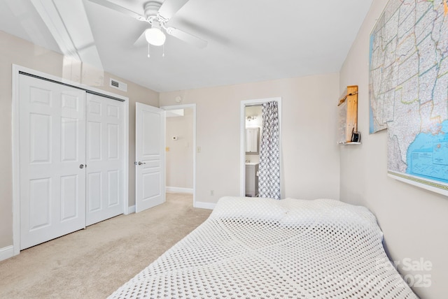 bedroom featuring baseboards, visible vents, a closet, and light colored carpet