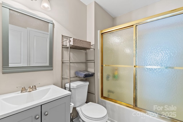 full bath featuring vanity, toilet, and bath / shower combo with glass door