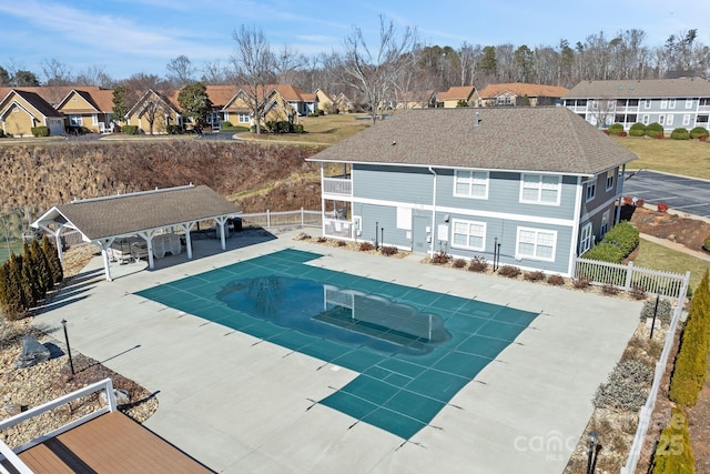 view of swimming pool featuring a patio area, a residential view, fence, and a fenced in pool