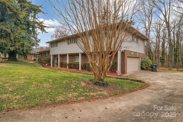 front of property with a garage and a front lawn