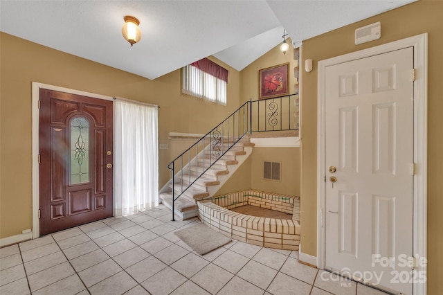 tiled foyer entrance with lofted ceiling