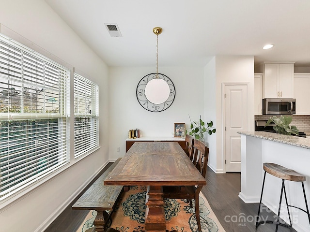 dining space featuring dark hardwood / wood-style flooring