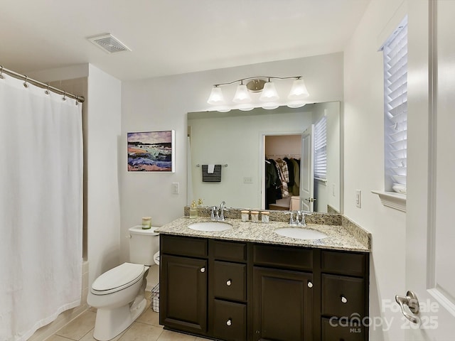 bathroom with tile patterned floors, vanity, and toilet