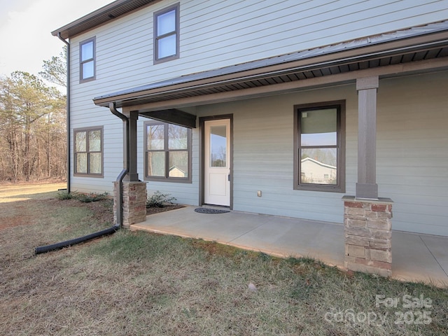 doorway to property with a yard