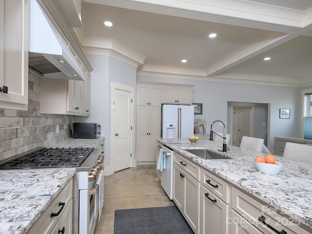 kitchen featuring wall chimney range hood, sink, dishwasher, white refrigerator with ice dispenser, and range with gas stovetop