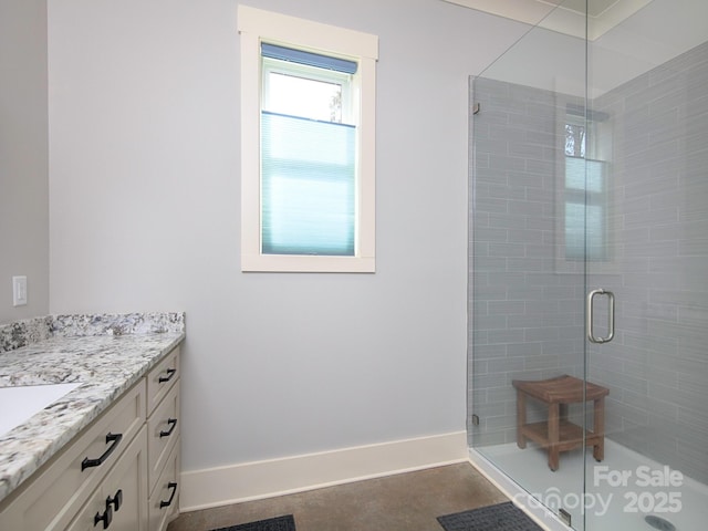 bathroom featuring walk in shower and vanity