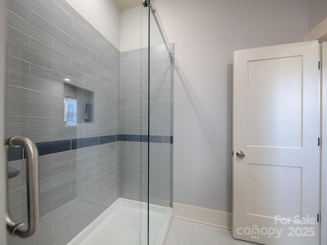 bathroom with tile patterned floors and an enclosed shower