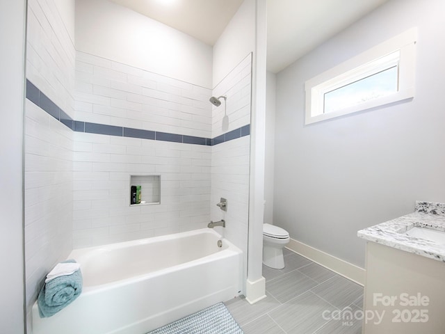 full bathroom featuring vanity, toilet, and tiled shower / bath