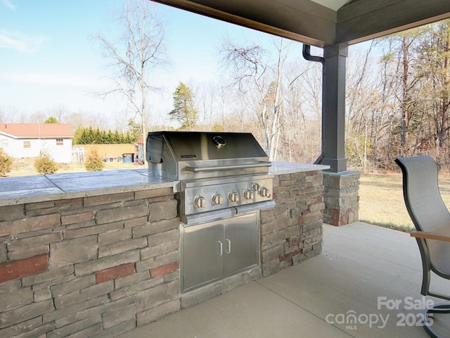 view of patio with an outdoor kitchen and area for grilling