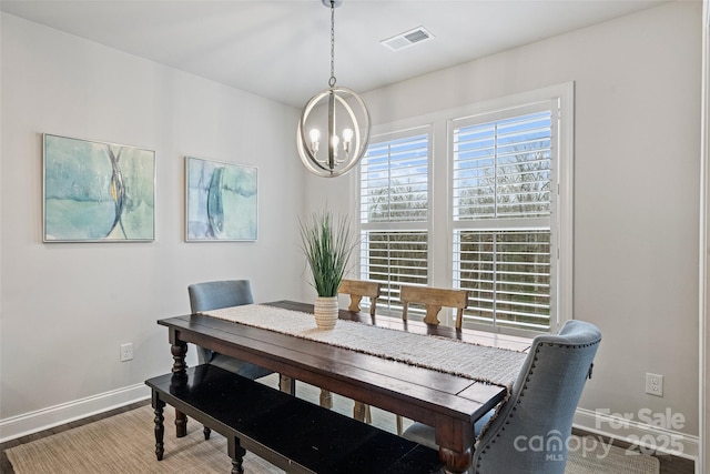 dining room featuring hardwood / wood-style flooring and a notable chandelier