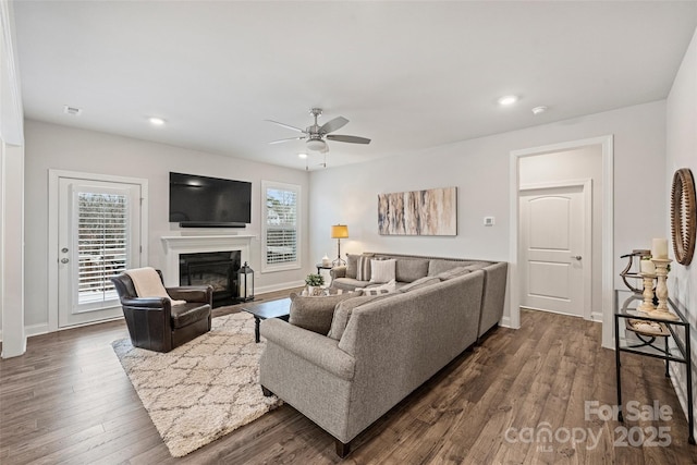 living room featuring dark hardwood / wood-style floors and ceiling fan