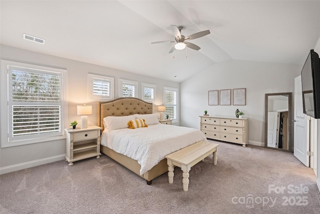 carpeted bedroom with vaulted ceiling and ceiling fan