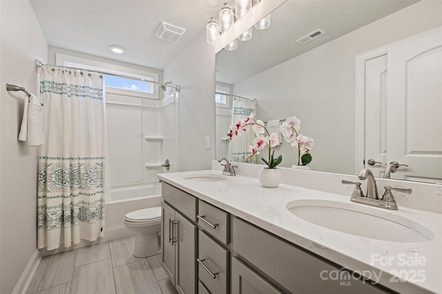 full bathroom with vanity, toilet, and shower / bath combo with shower curtain