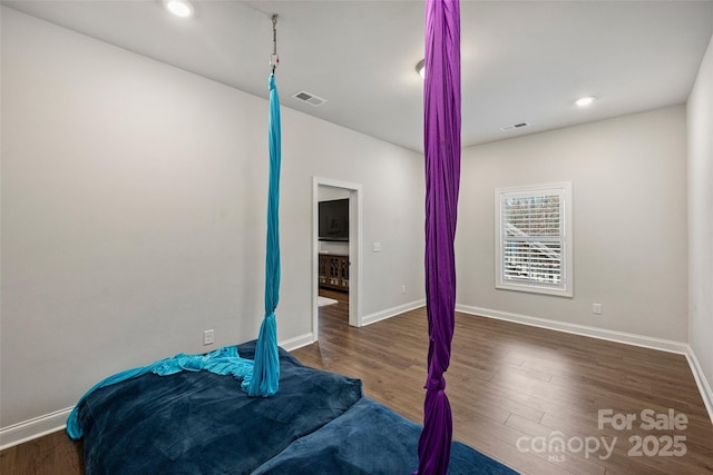 bedroom featuring dark hardwood / wood-style flooring