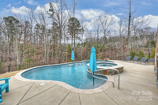 view of swimming pool featuring an in ground hot tub