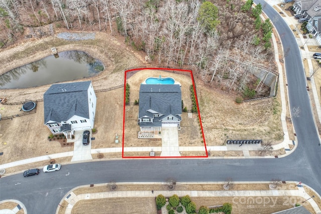 birds eye view of property with a water view