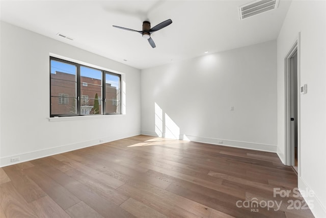 spare room with ceiling fan and wood-type flooring