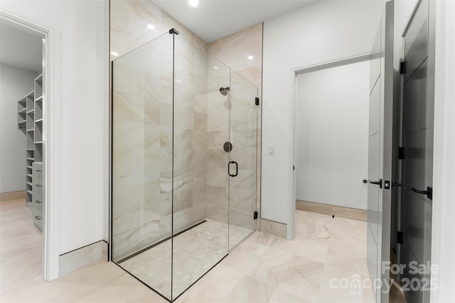 bathroom featuring a shower with shower door