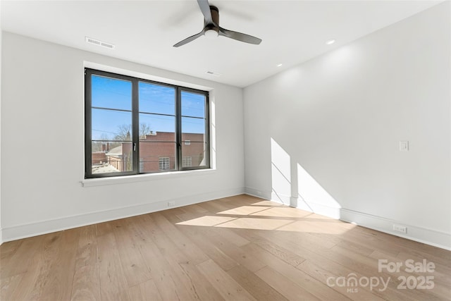 spare room featuring ceiling fan and light wood-type flooring