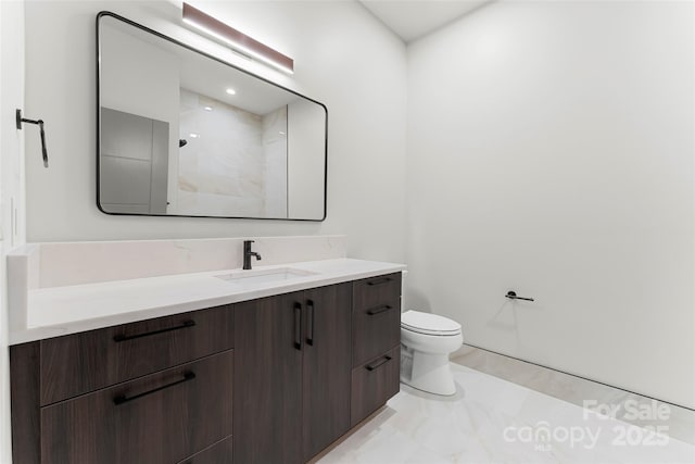 bathroom featuring vanity, toilet, and a shower