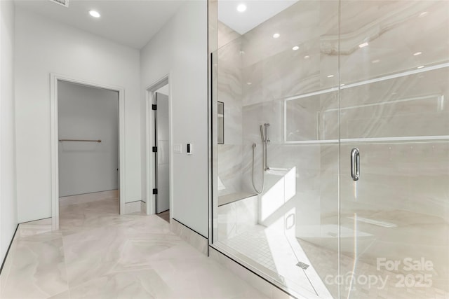 bathroom featuring a shower with shower door