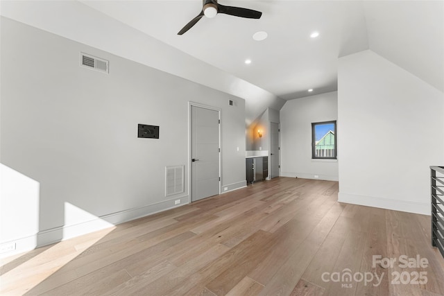 unfurnished living room with lofted ceiling, light hardwood / wood-style floors, and ceiling fan