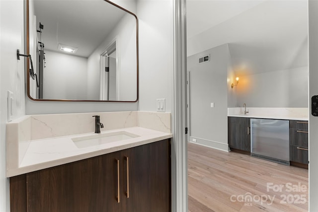 bathroom featuring hardwood / wood-style flooring and vanity