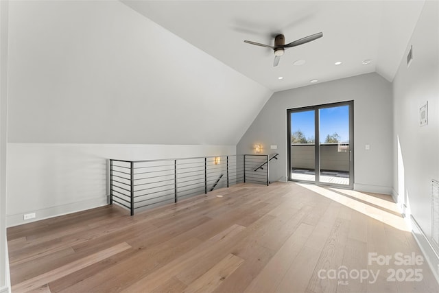 additional living space featuring light hardwood / wood-style flooring, ceiling fan, and vaulted ceiling