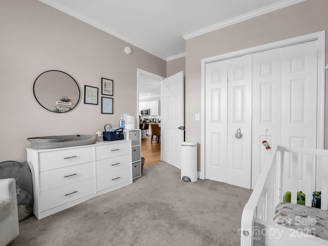 carpeted bedroom featuring crown molding and a closet