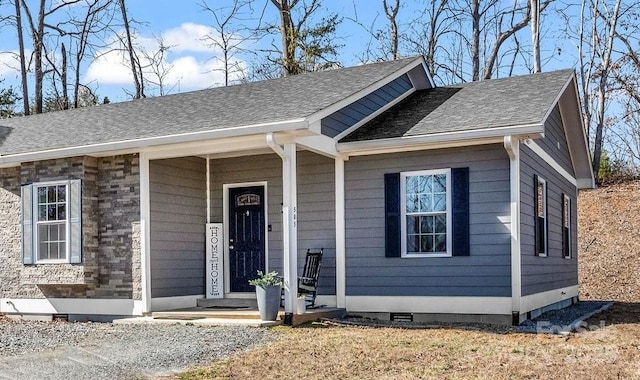 view of front of property featuring a shingled roof and crawl space