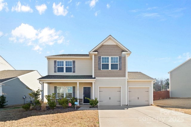 view of front of house featuring a garage, covered porch, fence, and concrete driveway