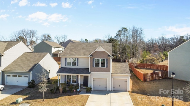 view of front of home featuring driveway and fence