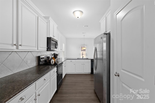 kitchen with black range with electric cooktop, white cabinets, a sink, and freestanding refrigerator