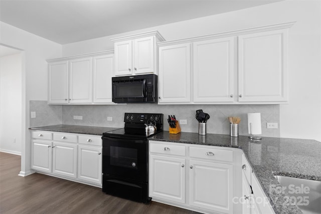 kitchen with black appliances, white cabinetry, dark wood-type flooring, and dark stone countertops