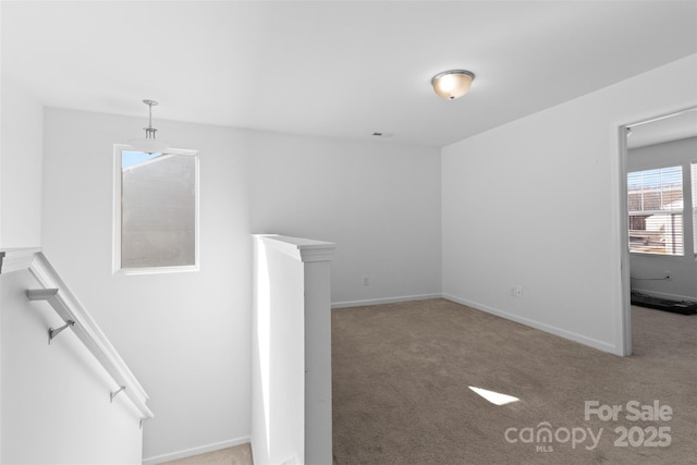 interior space featuring baseboards and carpet flooring